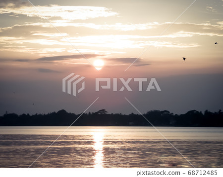 The sun in the sky in the evening, just before the sun goes down in the west. The sun in the sky in the evening, just before the sun goes down in the west. 68712485