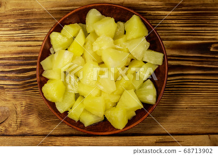 Canned pineapple pieces in ceramic plate  68713902
