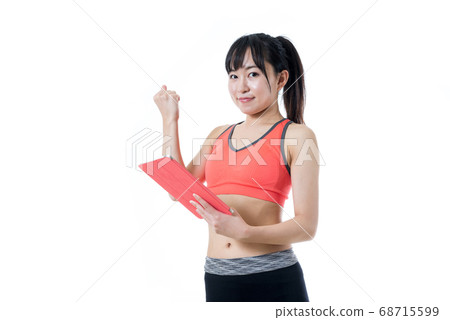 Young woman searching on tablet, muscle training girl 68715599