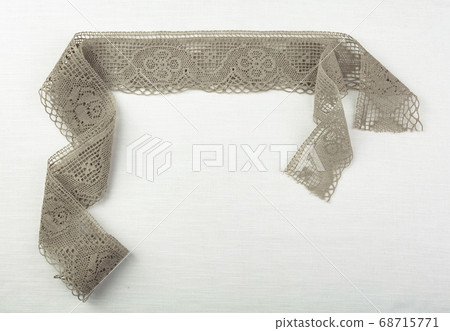 Lace on natural linen fabric. Lace on natural linen fabric. 68715771
