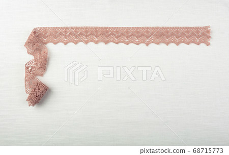 Lace on natural linen fabric. Lace on natural linen fabric. 68715773