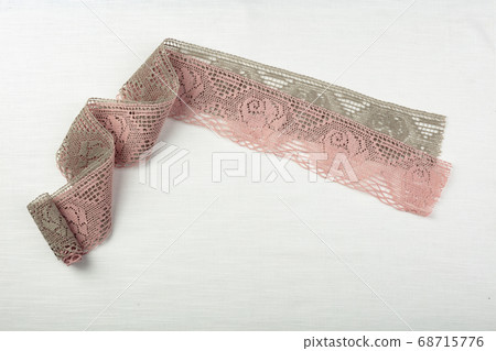 Lace on natural linen fabric. Lace on natural linen fabric. 68715776