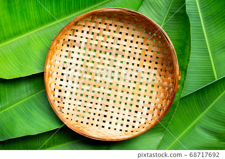 Empty wooden bamboo threshing basket on banana Empty wooden bamboo threshing basket on banana 68717692