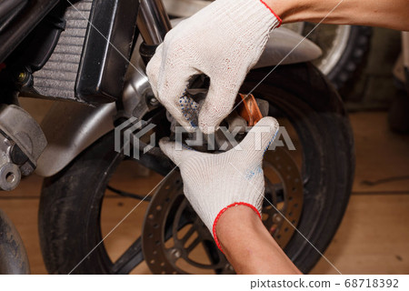 The process of replacing brake pads on a The process of replacing brake pads on a 68718392