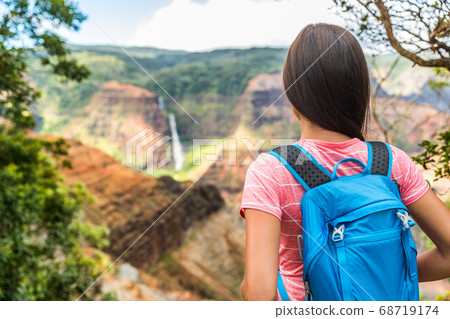 Hawaii hiking girl looking at Kauai waterfall 68719174