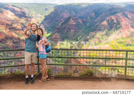 Hawaii travel tourists taking Waimea Canyon selfie Hawaii travel tourists taking Waimea Canyon selfie 68719177