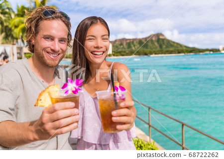 Happy people toasting at Waikiki beach bar party Happy people toasting at Waikiki beach bar party 68722262