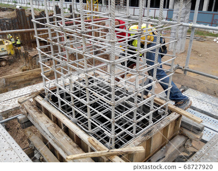 KUALA LUMPUR, MALAYSIA -MARCH 05, 2020: Construction workers installing & fabricating timber formwork at the construction site. The formworks made from timber and plywood. KUALA LUMPUR, MALAYSIA -MARCH 05, 2020: Construction workers installing & fabricating timber formwork at the construction site. The formworks made from timber and plywood. 68727920