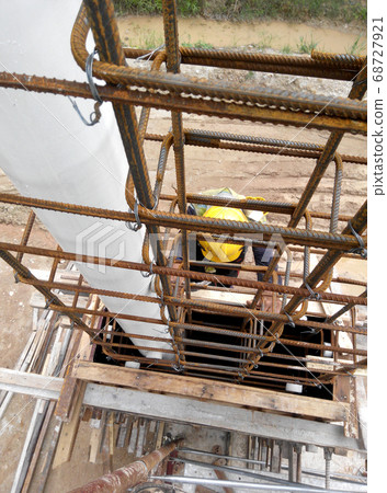 KUALA LUMPUR, MALAYSIA -MARCH 05, 2020: Construction workers installing & fabricating timber formwork at the construction site. The formworks made from timber and plywood. KUALA LUMPUR, MALAYSIA -MARCH 05, 2020: Construction workers installing & fabricating timber formwork at the construction site. The formworks made from timber and plywood. 68727921