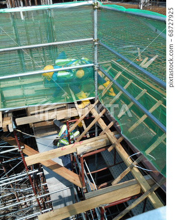 KUALA LUMPUR, MALAYSIA -MARCH 05, 2020: Construction workers installing & fabricating timber formwork at the construction site. The formworks made from timber and plywood. KUALA LUMPUR, MALAYSIA -MARCH 05, 2020: Construction workers installing & fabricating timber formwork at the construction site. The formworks made from timber and plywood. 68727925