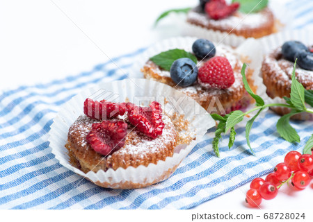 Mixed berry fruit muffins in paper cups Mixed berry fruit muffins in paper cups 68728024