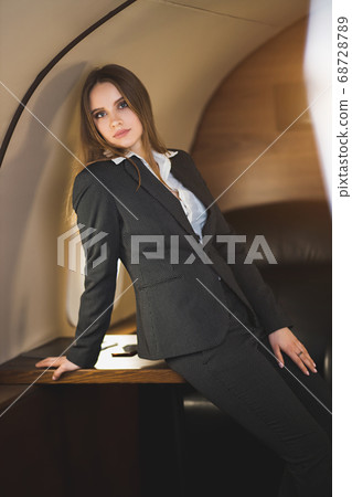 Attractive woman in private jet Attractive woman in private jet 68728789