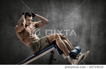 man bodybuilder perform exercise on prelum 68729016