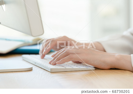 Hand of a woman operating a keyboard Hand of a woman operating a keyboard 68730201