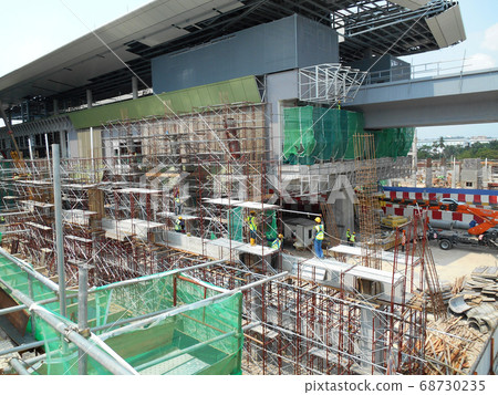 SERDANG, MALAYSIA -JUNE 13, 2016: Construction site in progress at Serdang, Malaysia during the daytime. Workers busy with their task installing formwork and reinforcement bar.      68730235