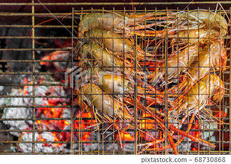 Grilled shrimps on charcoal stove. 68730868