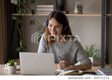 Happy young woman look at laptop studying online 68731218