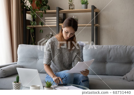 Young woman manage household finances paying online 68731440