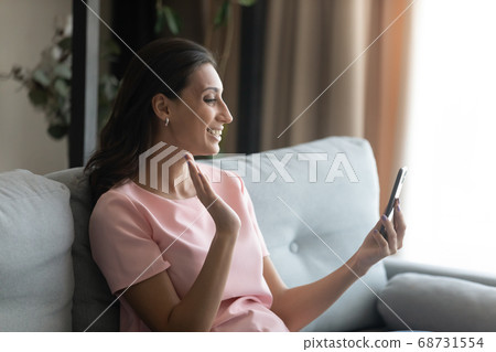 Happy ethnic female talk on video call using smartphone 68731554