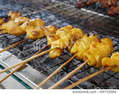 KUALA LUMPUR, MALAYSIA -AUGUST 17, 2018: Malaysian famous traditional food called sate. Meat or chicken marinated with mix spices and grill using hot charcoal. Grill in action. 68732660