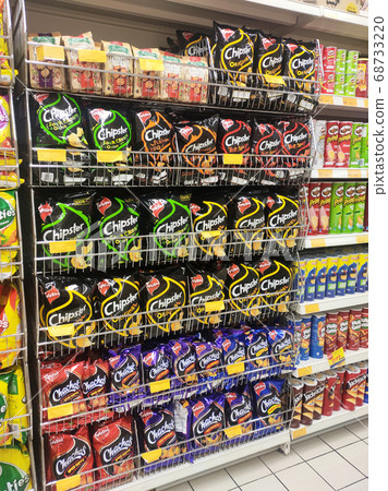 KUALA LUMPUR, MALAYSIA -APRIL 27, 2020: Selective focused of packed miscellaneous brand and type of junk foods & snacks on rack and display for sale in the supermarket. Each has its own price tag.  68733220