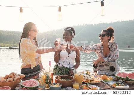 Woman toasting with wine 68733313
