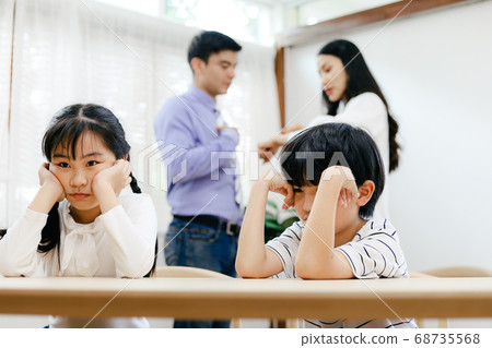 Family problems concept, father and mother quarreling in the house so causing children to feel bad. 68735568