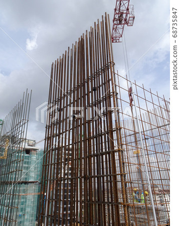 KUALA LUMPUR, MALAYSIA -AUGUST 05, 2017: Steel reinforcement bar used to reinforced concrete at the construction site. It was tied together using tiny wires by construction workers. KUALA LUMPUR, MALAYSIA -AUGUST 05, 2017: Steel reinforcement bar used to reinforced concrete at the construction site. It was tied together using tiny wires by construction workers. 68735847