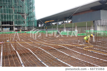 SELANGOR, MALAYSIA -JANUARY 18, 2017: Slab steel reinforcement bar laid on top of timber form work to form part of the floor slab structure after poured with concrete. SELANGOR, MALAYSIA -JANUARY 18, 2017: Slab steel reinforcement bar laid on top of timber form work to form part of the floor slab structure after poured with concrete. 68735868