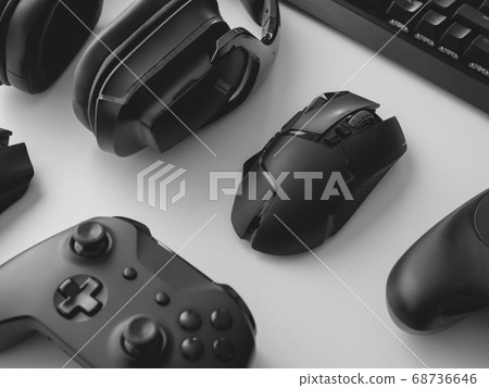 gamer work space with gaming gear, mouse, keyboard, joystick, headset on white table background. 68736646