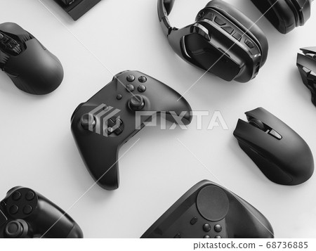 gamer work space with gaming gear, mouse, keyboard, joystick, headset on white table background. 68736885