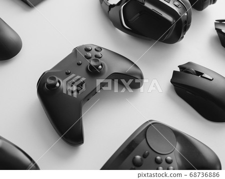gamer work space with gaming gear, mouse, keyboard, joystick, headset on white table background. gamer work space with gaming gear, mouse, keyboard, joystick, headset on white table background. 68736886