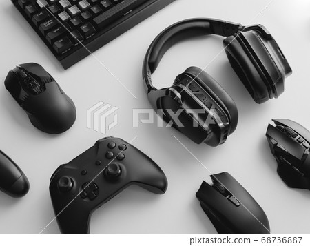 gamer work space with gaming gear, mouse, keyboard, joystick, headset on white table background. gamer work space with gaming gear, mouse, keyboard, joystick, headset on white table background. 68736887