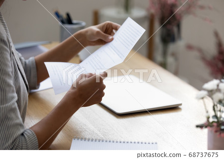 Close up young woman holding paper letter with good news. 68737675