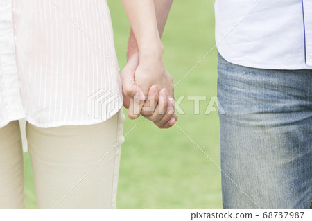 A couple connecting hands A couple connecting hands 68737987