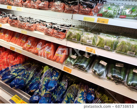 KUALA LUMPUR, MALAYSIA - JULY 16, 2020: Vegetables packed inside a plastic container and plastic wrap. Displayed on the cool chiller rack inside the supermarket. KUALA LUMPUR, MALAYSIA - JULY 16, 2020: Vegetables packed inside a plastic container and plastic wrap. Displayed on the cool chiller rack inside the supermarket. 68738653