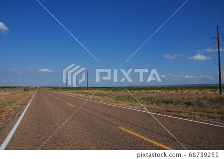 A long straight Route 66 road between Texas and New Mexico, USA. August 4, 2007. 68739251