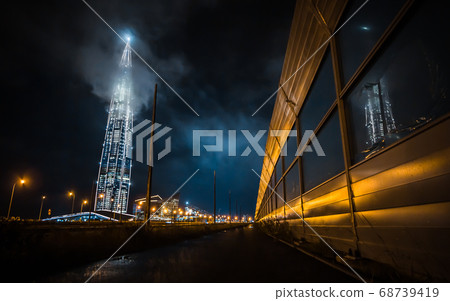 Russia, St. Petersburg, July -2020:night view of the city of St. Petersburg, view of the skyscraper business center of Gazprom, Lakhta center. the tallest building in Europe.Reflection in noise shield 68739419