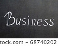Chalk business word text on black background. 68740202