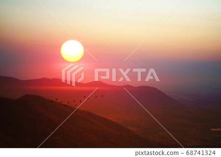 sunrise on morning sky over green mountain and 68741324