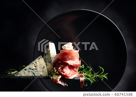 Prosciutto or spanish jamon with blue cheese and 68741586