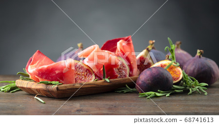 Prosciutto with figs and rosemary. Prosciutto with figs and rosemary. 68741613