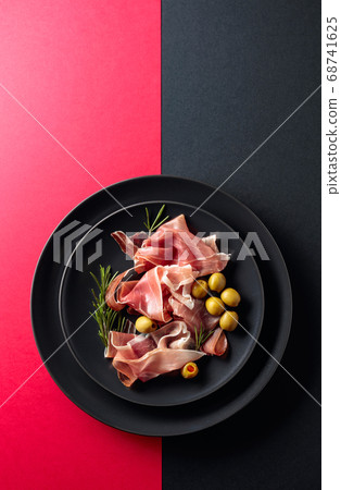 Prosciutto with rosemary and green olives on a 68741625