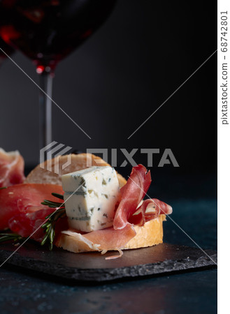 Sandwich with prosciutto, blue cheese and rosemary Sandwich with prosciutto, blue cheese and rosemary 68742801