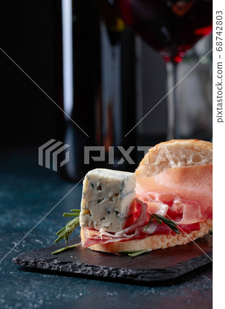 Sandwich with prosciutto, blue cheese and rosemary Sandwich with prosciutto, blue cheese and rosemary 68742803