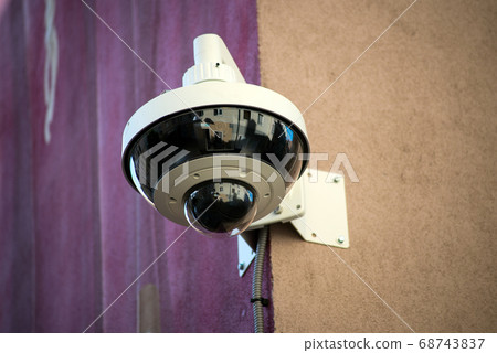 Closeup of security camera on stoned wall Closeup of security camera on stoned wall 68743837