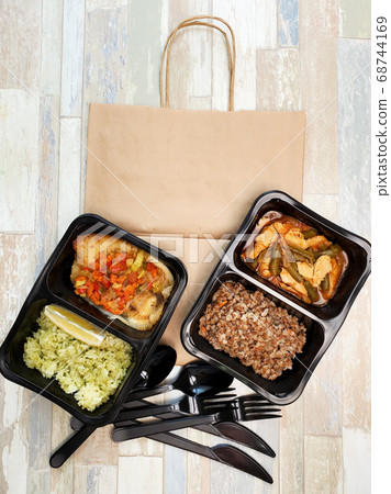 Healthy food in plastic boxes, the top view, the concept of delivery Healthy food in plastic boxes, the top view, the concept of delivery 68744169