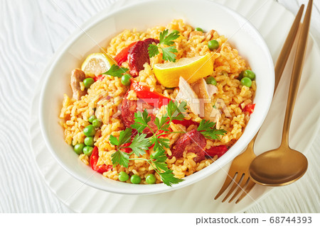 spanish chicken paella on a white plate 68744393