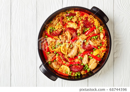 spanish chicken paella in a black dish spanish chicken paella in a black dish 68744396