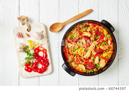spanish chicken paella in a black dish spanish chicken paella in a black dish 68744397